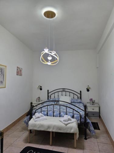 a bedroom with a bed and a light fixture at Casa Grilla in Assemini