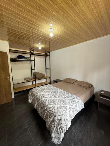 a bedroom with a bed and two bunk beds at Casa del parque in Oberá