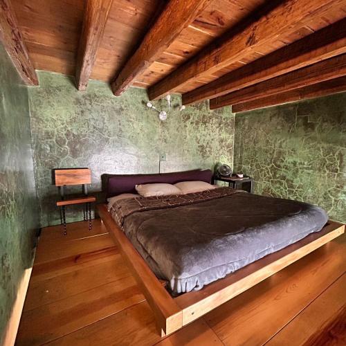 a bedroom with a large bed in a room with wooden ceilings at Latidos del Centro de CDMX in Mexico City