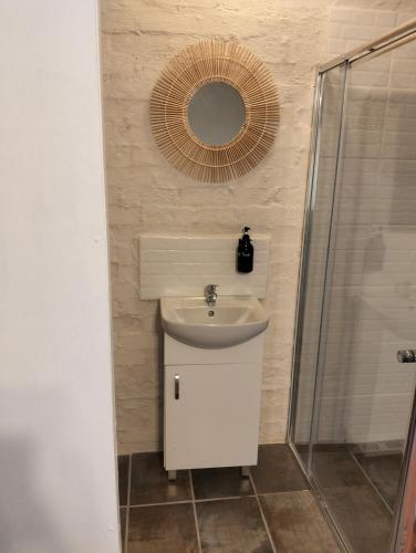 a bathroom with a sink and a mirror at Golden Mile Estate Self Check Inn in eMalahleni