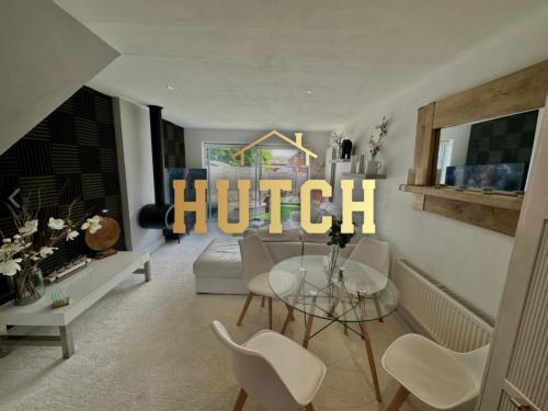 a living room with a dining table and a chandelier at Fantastic 2-Bed House with Parking - Hosted by Hutch Lifestyle in Leamington Spa