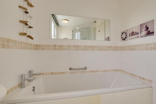a bathroom with a large white sink and a mirror at 4 Bed in Reydon oc-fll in Reydon