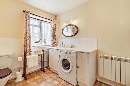 a bathroom with a washing machine and a sink at 1 Bed in St. James South Elmham Halesworth oc-t27361 in Saint James