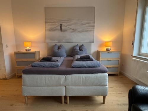 a bedroom with a large bed with two pillows at 35qm2, Whirlpool & Queensize-Bett, Terrasse 50qm2, Self-Checkin, eigener Parkplatz, Nähe Ulm und Universität in Blaustein