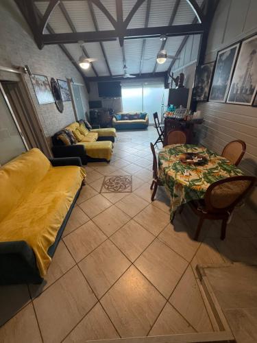 a room with a bed and a table and chairs at residence caramboles in Fort-de-France