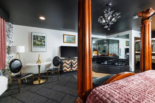 a bedroom with a bed and a table and a mirror at Hotel J Green Bay in Green Bay