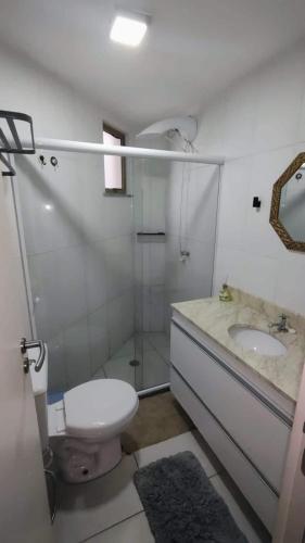 a bathroom with a toilet and a shower and a sink at Casa Mobiliada - Praia Imbassaí in Imbassai