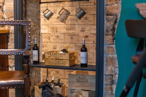 a shelf with two bottles of wine on a wall at Tithe Barn - Self Check In Hotel in Cockermouth