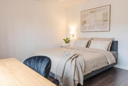a bedroom with a bed with a blanket on it at Dreiländer-Blick Apartment 2 Schlafzimmer in Lörrach
