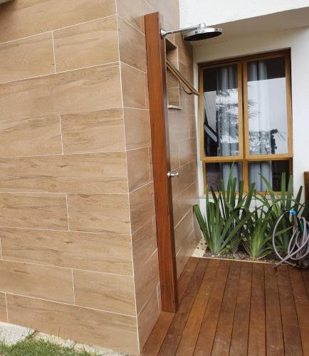 a wooden door to a house with a wooden deck at Casa Mobiliada - Praia Imbassaí in Imbassai