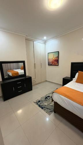 a bedroom with two beds and a mirror at Artem Apartments - Apartment 1 in Kitwe
