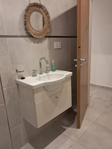 a bathroom with a white sink and a mirror at Monoambiente zona UNNE in Resistencia