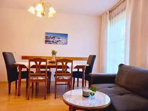 a living room with a table and chairs and a couch at Landhof Kreuzsalgut in Wagrain