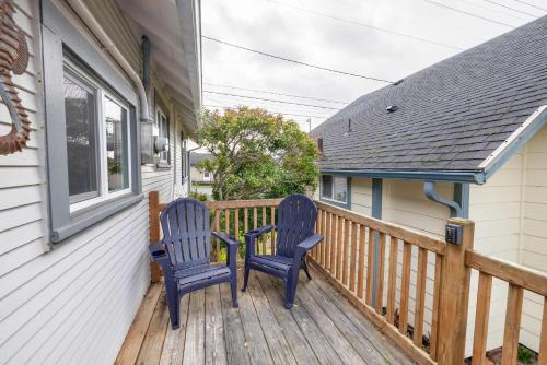 two blue chairs sitting on the porch of a house at Coho Cottage in Rockaway Beach