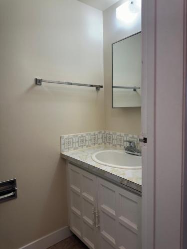 a bathroom with a sink and a mirror at Your private room CozyVibe in Edmonton
