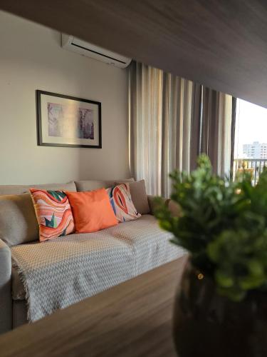 a living room with a couch and a window at Emilie Home in Sao Jose do Rio Preto
