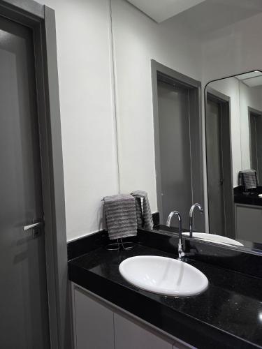 a bathroom with a sink and a mirror at Emilie Home in Sao Jose do Rio Preto