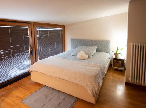 a bedroom with a bed with a stuffed animal on it at Egea Beach House in Lido di Camaiore