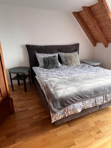 a bedroom with a large bed with two tables at Ferienwohnung Hansnhof in Wilhelmsthal