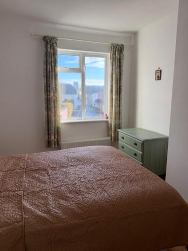 a bedroom with a bed and a window at 3 bedroom cottage Brecon sleeps 4 in Brecon