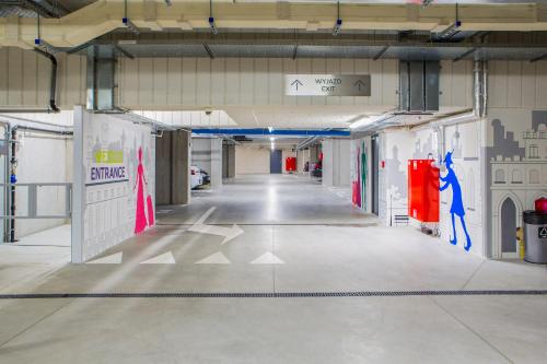 a hallway in a building with a parking garage at Mercure Krakow Stare Miasto in Kraków