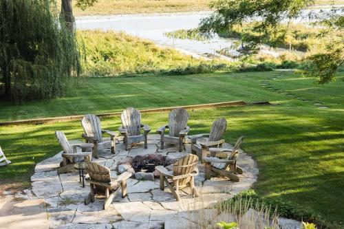 a group of chairs and a fire place in a yard at The Great Escape Blocks From Your Private Beach in New Buffalo