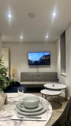 a living room with a couch and a table at The perfect one bed stay in Central Station