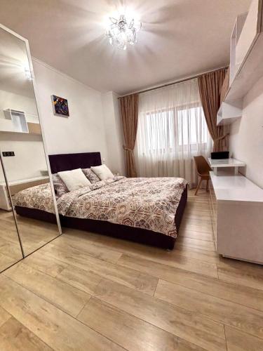 a bedroom with a bed and a mirror at Sweet Home Apartment in Piteşti