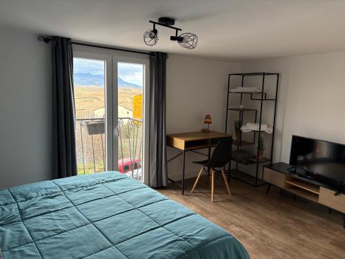 a bedroom with a bed and a desk and a window at Casa iulia in Haro