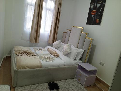 a bed with a headboard and pillows in a room at Wema m stays in Munyu