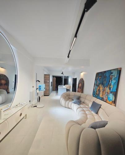 a living room with a large couch and a mirror at B's House in Pointe-à-Pitre