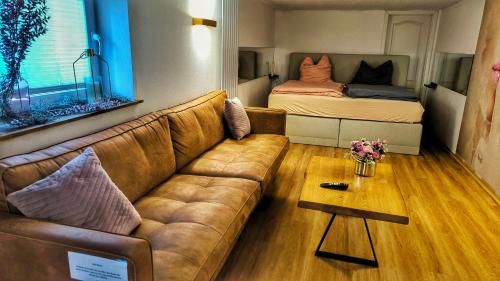 a living room with a couch and a bed at AMORE 66 bei Greta in Marl