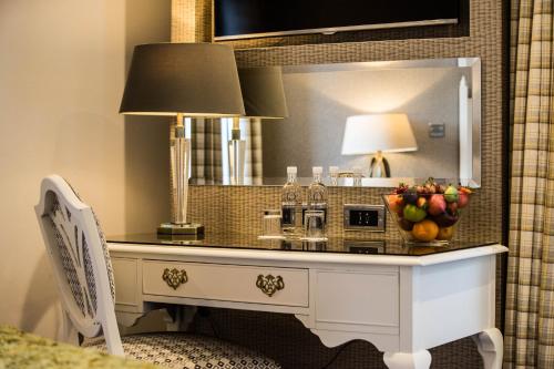 a dressing table in a room with a mirror at Gleddoch Golf & Spa Resort in Langbank
