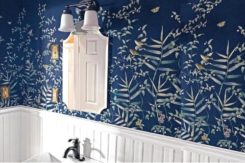 a bathroom with blue floral wallpaper and a sink at The Ivywood in Guerneville