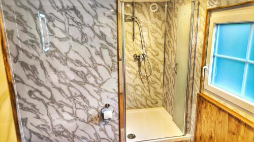 a bathroom with a shower with a glass door at bei GRETA Wohnung 77 in Marl