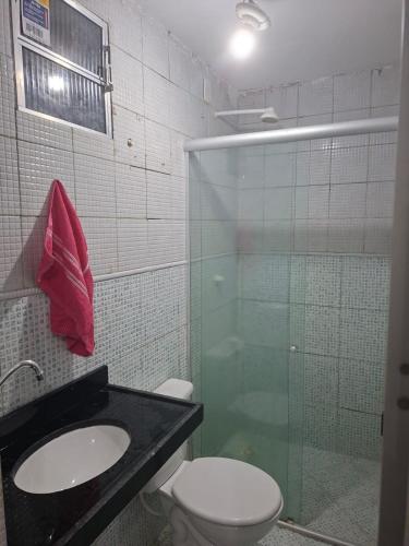 a bathroom with a toilet and a glass shower at Apto 04 em São Bras in Belém