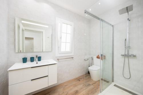 a white bathroom with a sink and a shower at Villa Yaiza Secret 1 in Yaiza