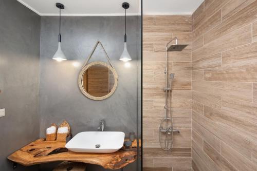 a bathroom with a sink and a shower at Irida sunset in Pentátion