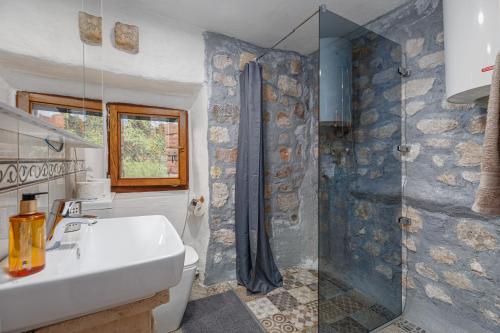 a bathroom with a shower and a sink and a toilet at HealthyStudio512 Apartments in Kotor