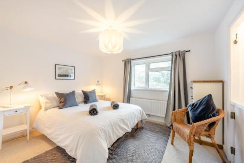 a bedroom with a large white bed and a window at 3 Bed in Croyde oc-s34664 in Croyde