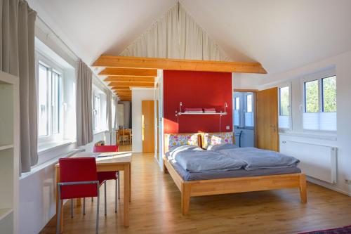 a bedroom with a bed and a table and chairs at Apartment Haak in Halle Westfalen