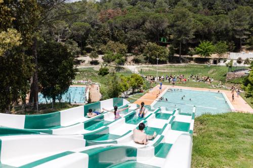 a group of people in a swimming pool at EL COLLELL - Complejo Familiar in Sant Ferriol