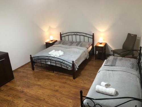 a bedroom with two beds and a chair in it at Apartmány Apollón in Liberec