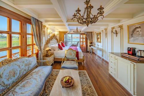 a living room with a couch and a table at Princess Farida Luxury Dahabiya Nile Cruise, Every Monday from Luxor to Aswan 4 nights and Every Friday from Aswan to Luxor 3 nights in Luxor