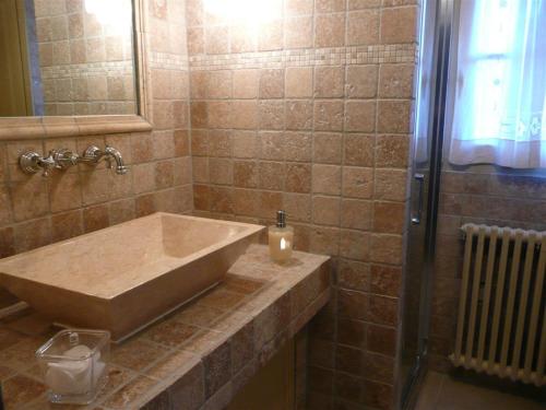 a bathroom with a large sink and a shower at Mas les vieux chênes in Lambesc