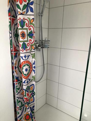 a bathroom with a shower with a tile wall at Apartment Haak in Halle Westfalen