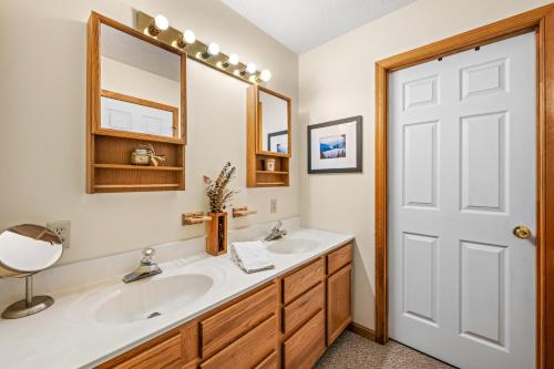 a bathroom with two sinks and a mirror at Healing House - Healing Escape in Berkeley Springs