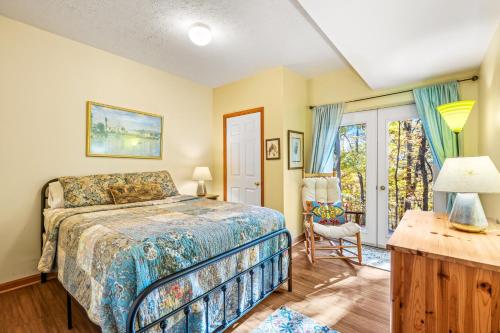 a bedroom with a bed and a desk and a window at Healing House - Healing Escape in Berkeley Springs