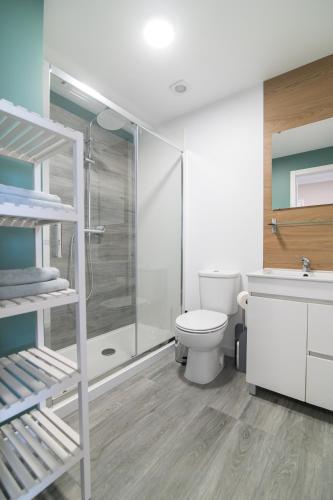 a bathroom with a toilet and a shower and a sink at Livramento Residence in Livramento