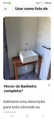 a bathroom with a white sink in a room at Loft centro do universo in Arroio do Sal